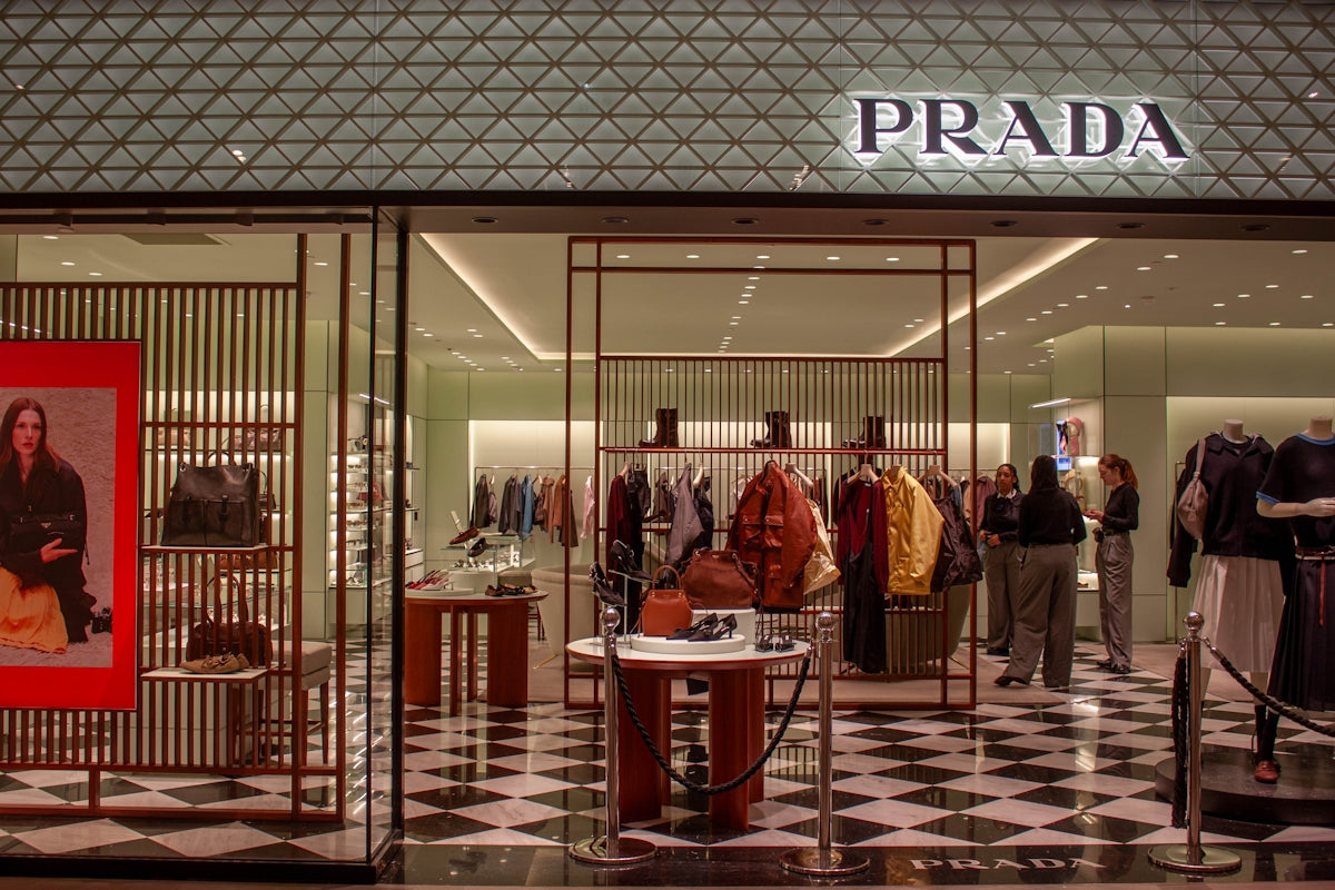 Prada store entrance with mannequins and clothing displays