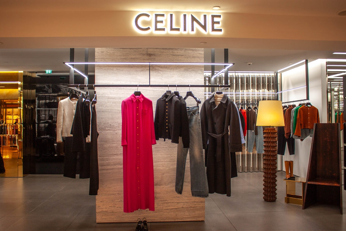 Celine store interior with clothing racks and display.