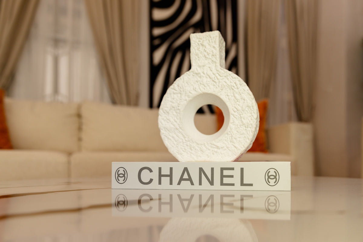 White decorative object on a chanel block with reflection.