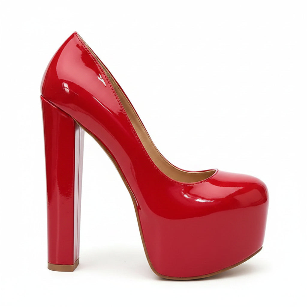 Shiny red high-heeled shoe on a brown surface with a blurred background
