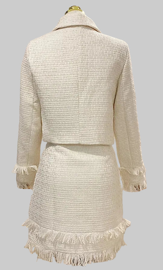 Beige textured suit with fringes on a light gray background