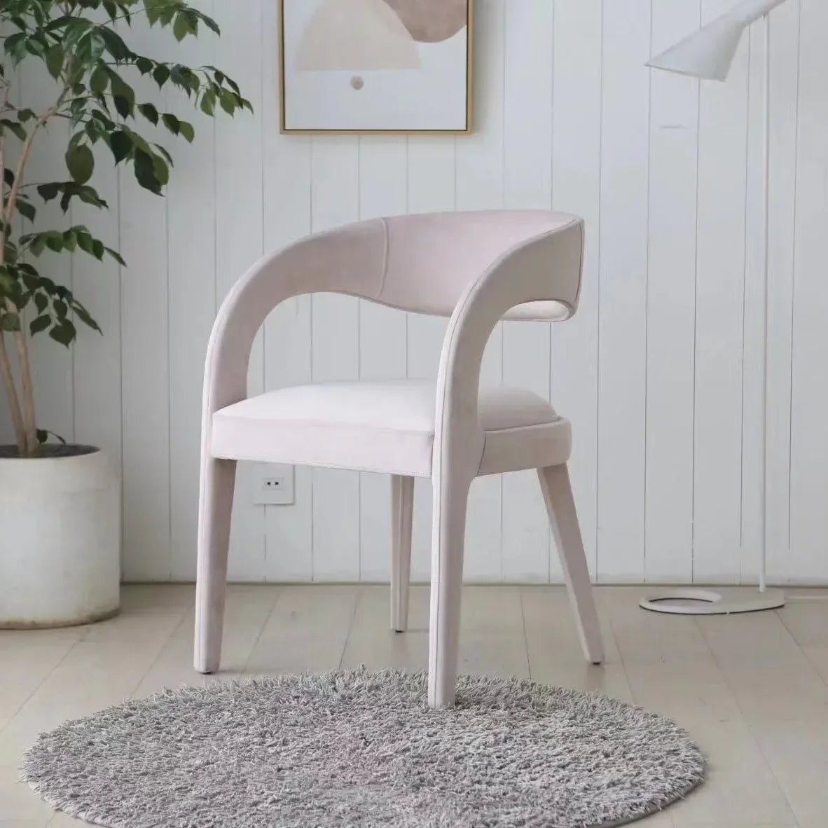 A Nordic minimalist modern designer shaped armchair living room dining room dining chair