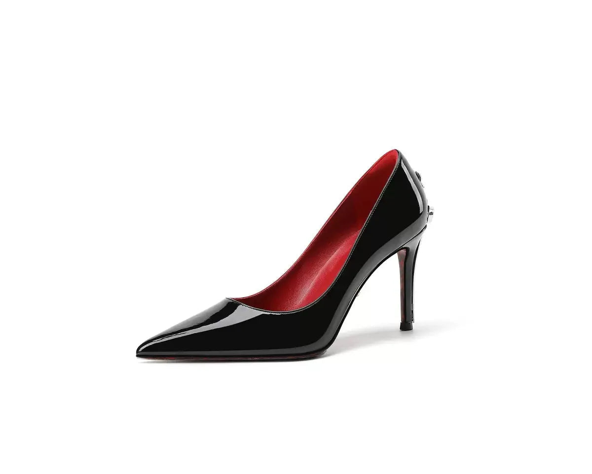 Black high-heeled shoe with red interior on a white background