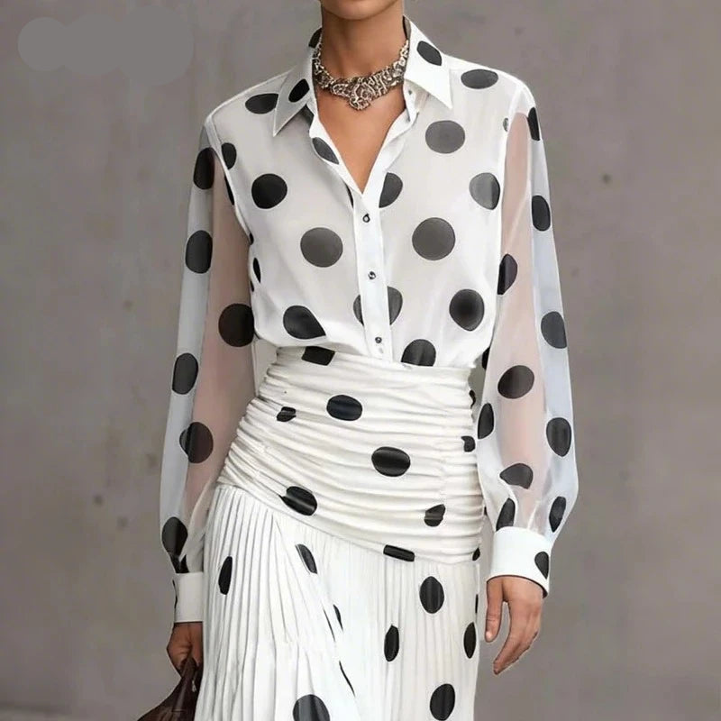 A woman models a white long-sleeve blouse with large black polka dots and sheer sleeves, paired with a matching pleated skirt. The image includes the text overlay 'Only tops' in the top-left corner.
