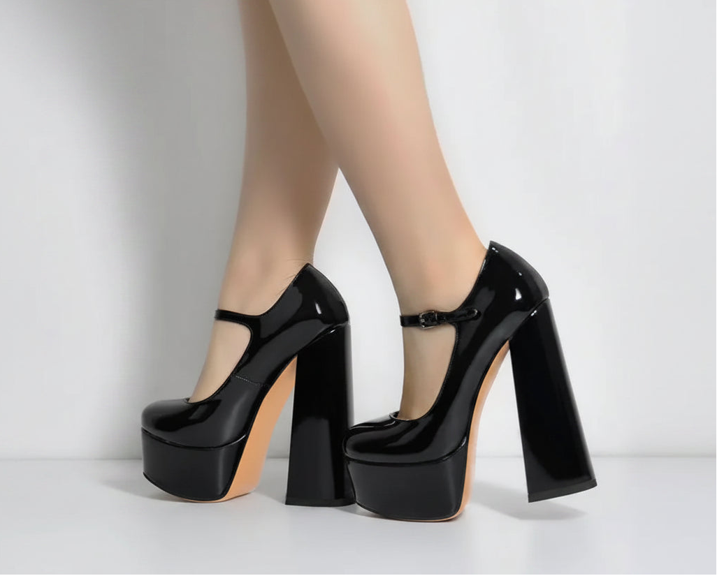 Black high-heeled shoes with a platform sole worn by a person on a white background, featuring the brand 'Only Maker'.