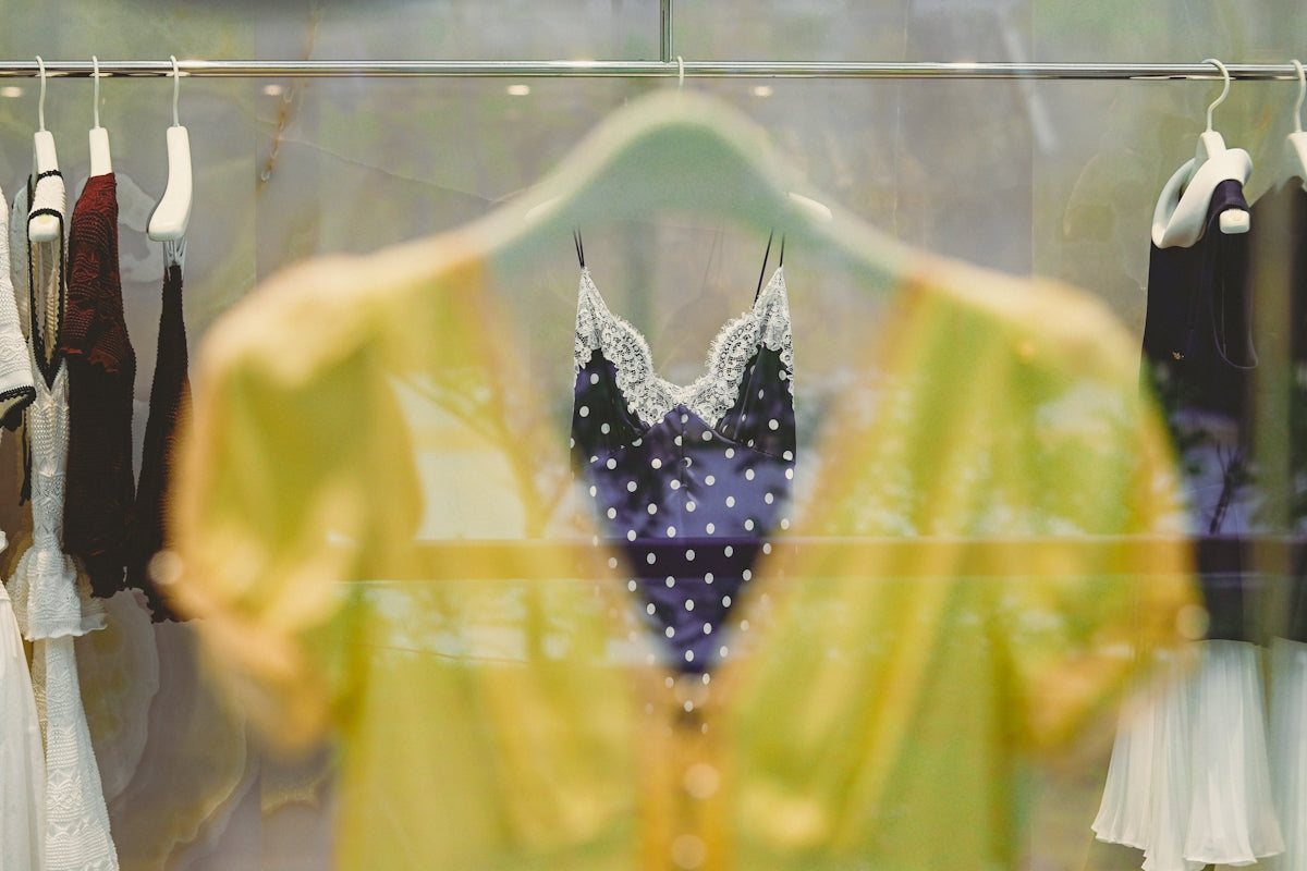 Yellow shirt and blue polka-dot top in a store window.