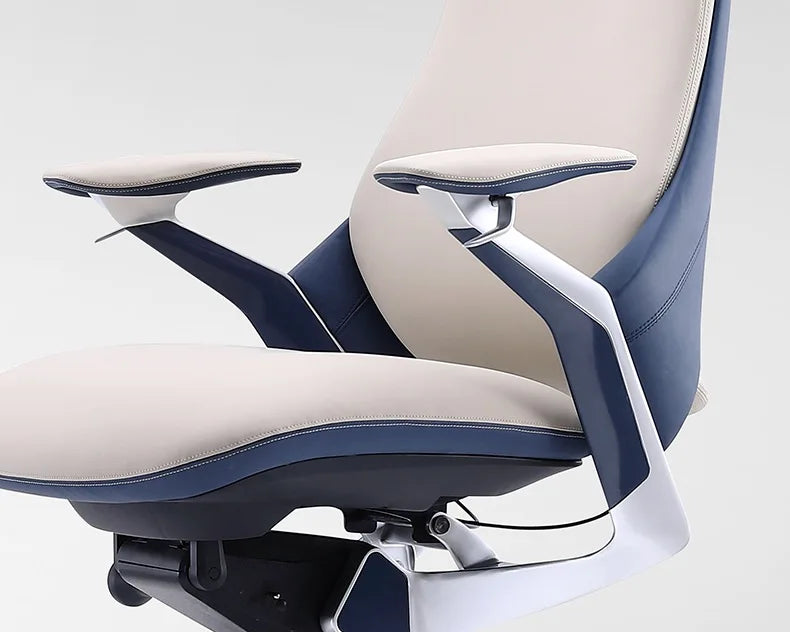 Close-up of a modern office chair showing the backrest, armrest, and seat in navy blue and light beige upholstery with a glossy silver metal frame.