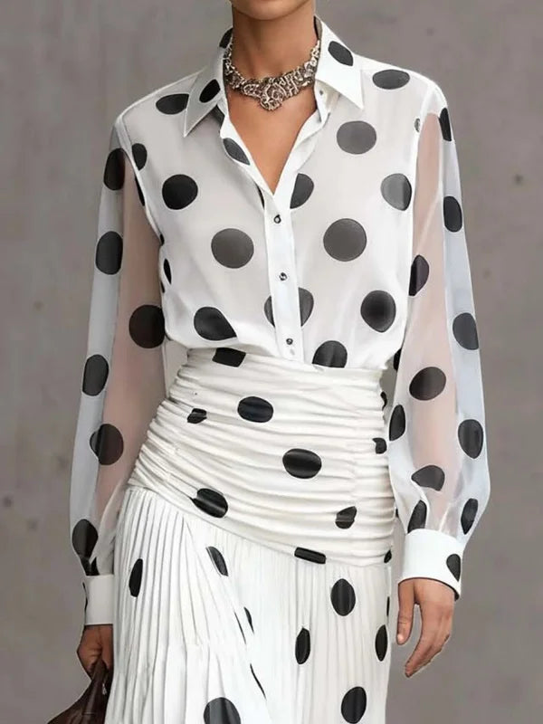 White outfit with black polka dots on a plain background
