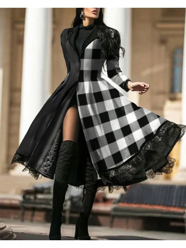 Woman wearing a black and white checkered dress with a long coat in an outdoor setting.