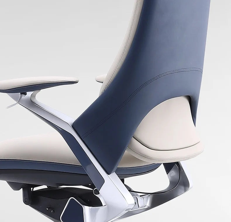 Close-up of a modern office chair showing the backrest, armrest, and seat in navy blue and light beige upholstery with a glossy silver metal frame.
