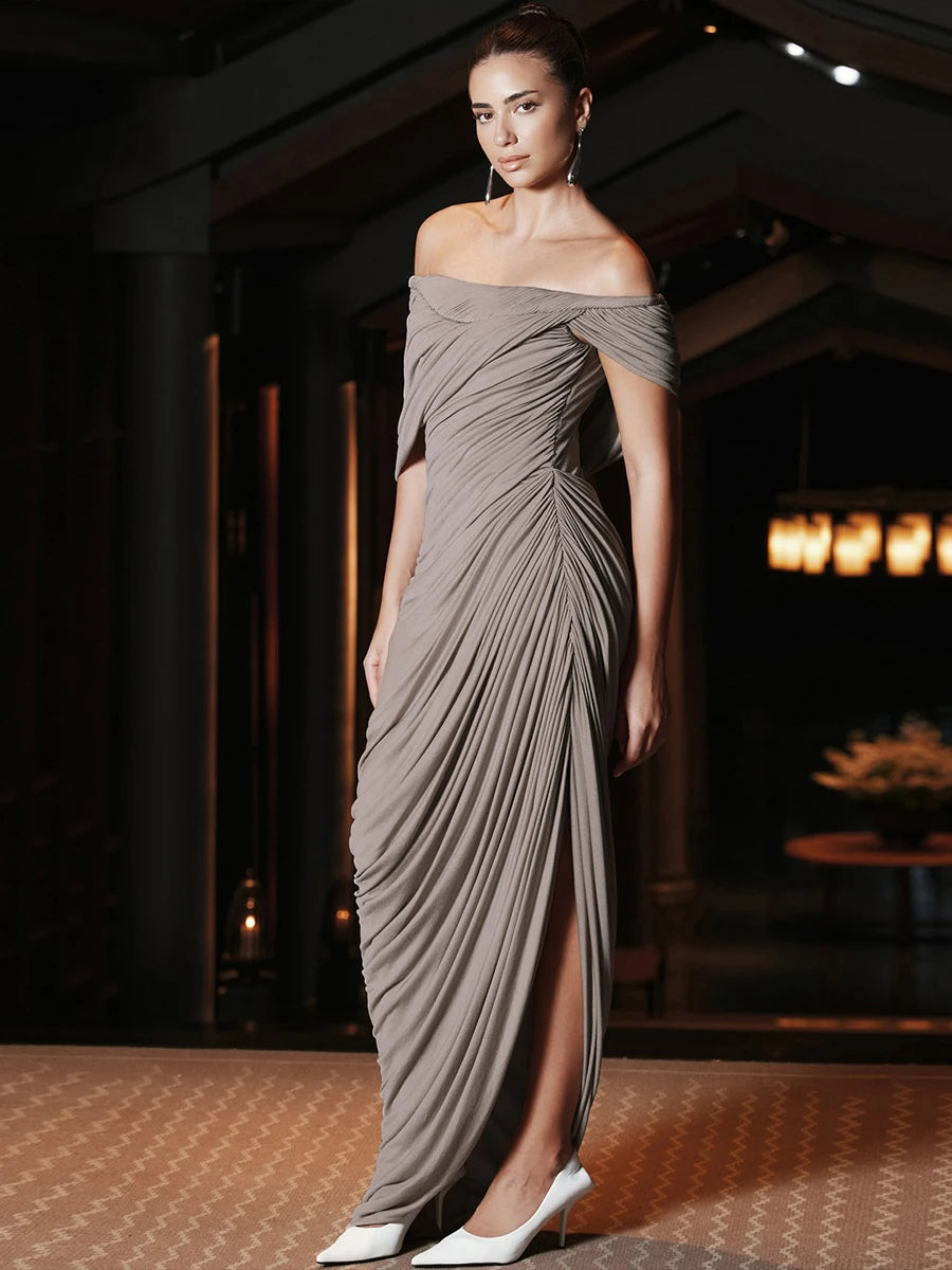 Woman wearing a gray off-shoulder gown in an indoor setting