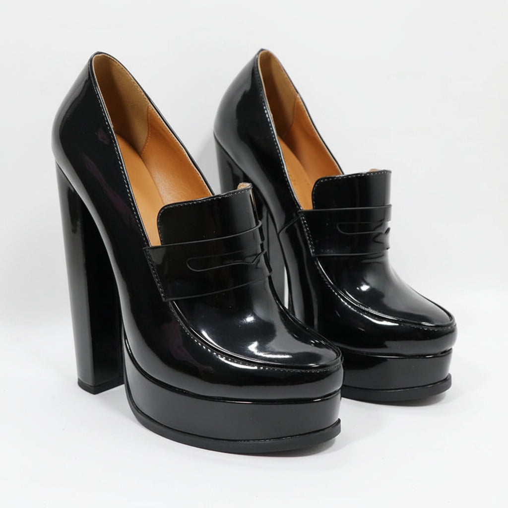 A pair of black patent leather high-heeled pumps with platform soles and wide straps, shown on a white background with the Sorbern brand logo in the top left corner.