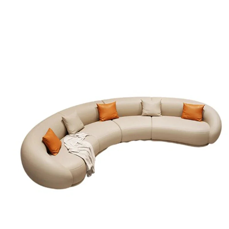Curved beige sofa with orange cushions on a white background