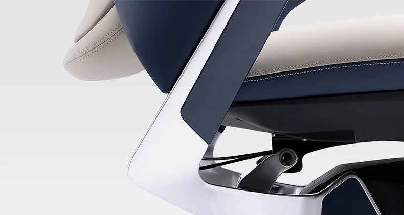 Close-up of a modern office chair showing the backrest, armrest, and seat in navy blue and light beige upholstery with a glossy silver metal frame.