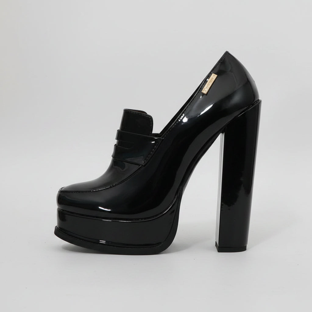 A single black patent leather high-heeled shoe with a chunky block heel and platform sole, shown next to a measuring tape on a white background. The brand name 'Sorbern' is printed in the top left corner.