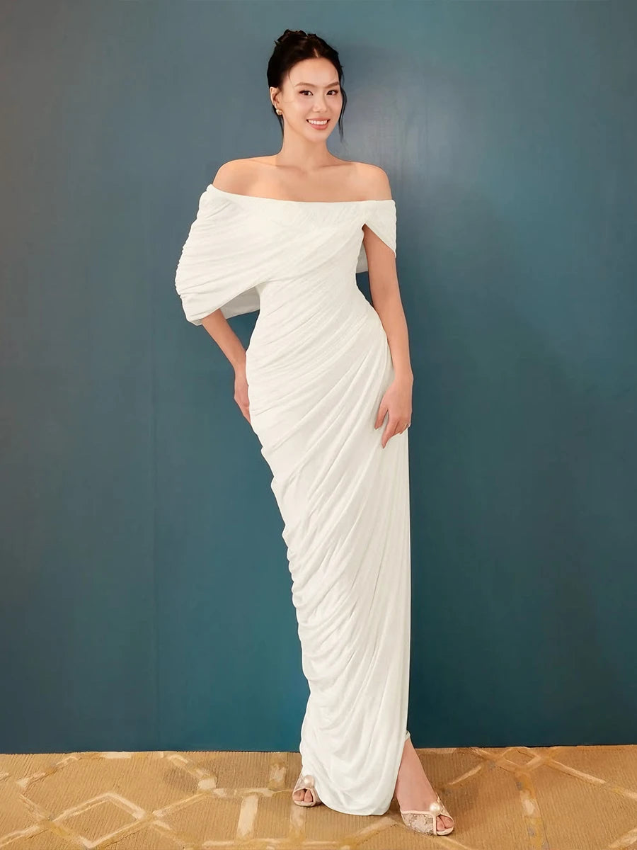 Woman wearing a white off-shoulder gown against a blue background