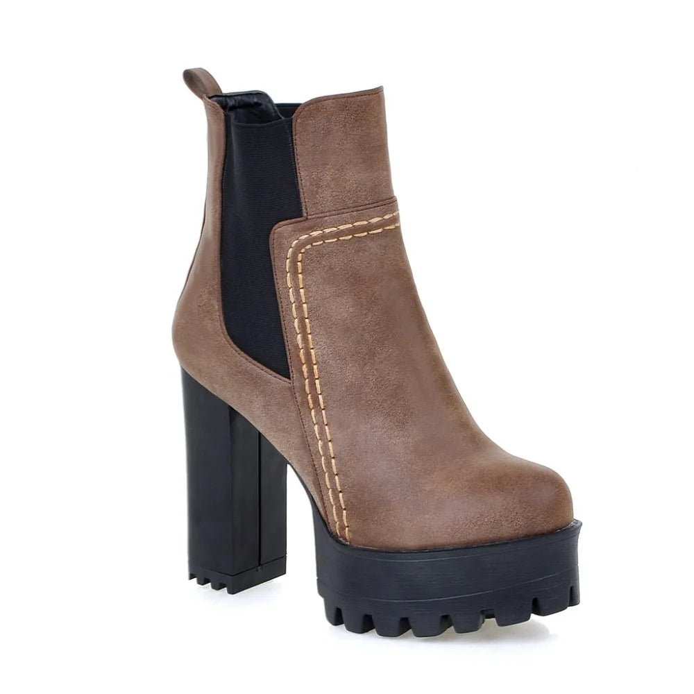 Brown ankle boot with black sole on a white background