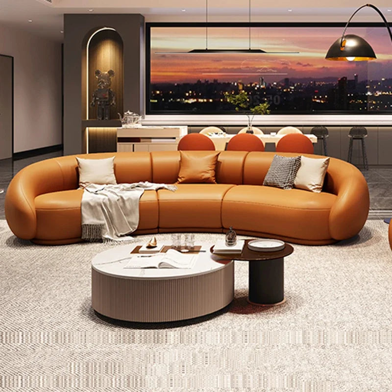 Modern living room with a large brown sectional sofa and a cityscape view.