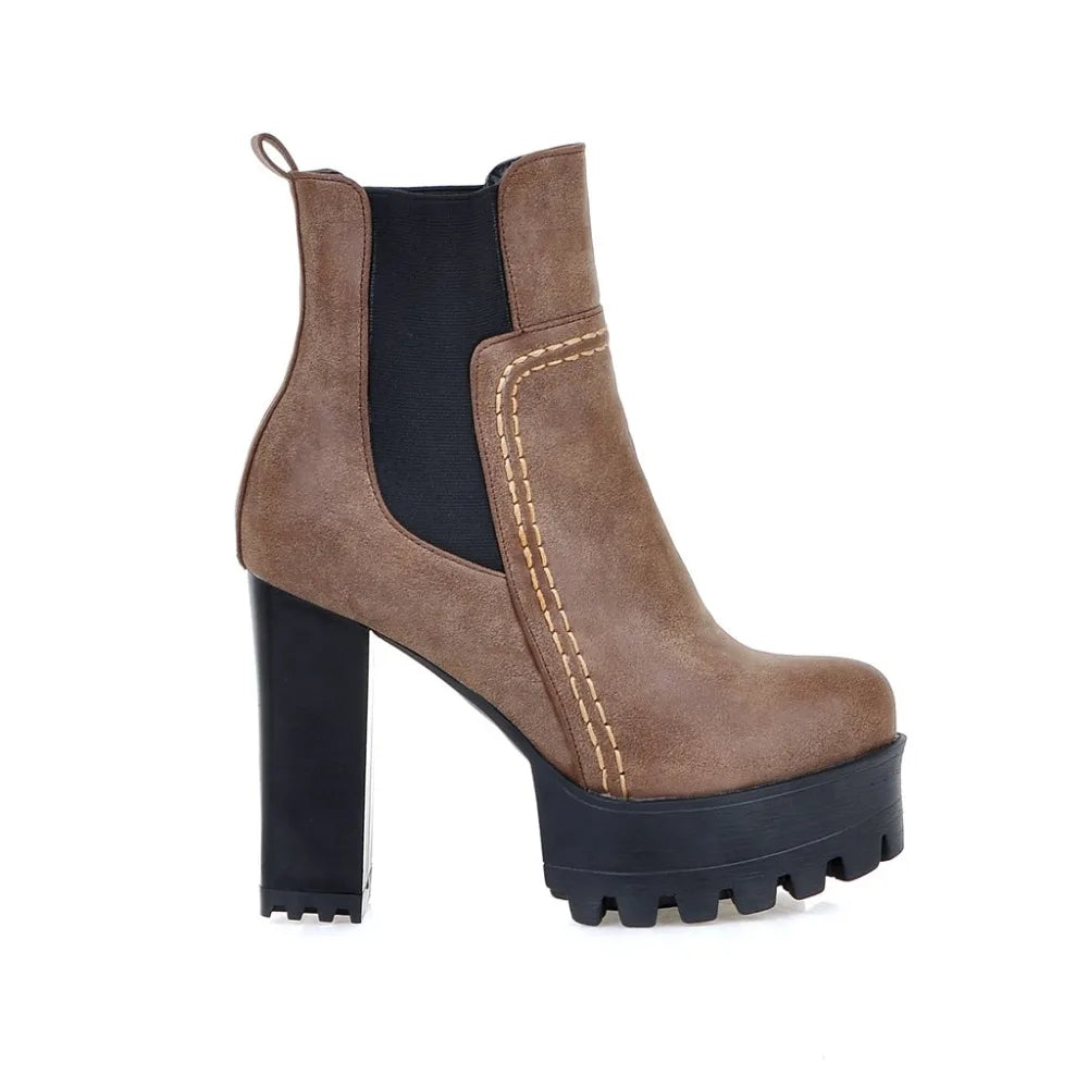 Brown platform boot with black sole on a white background